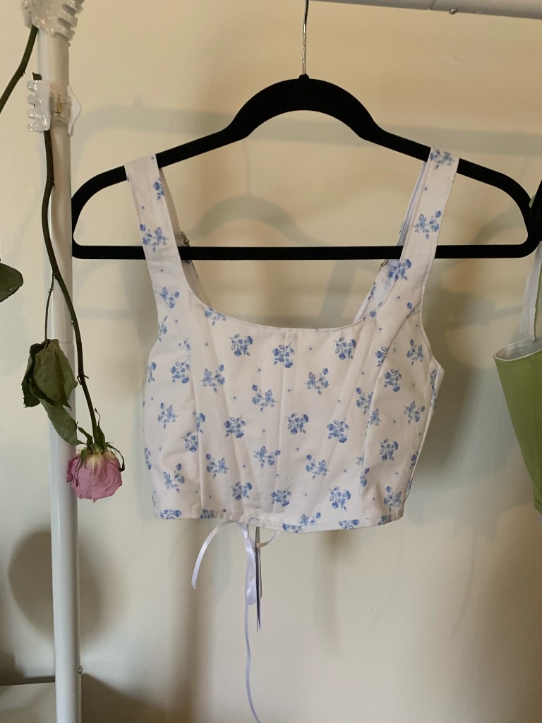 Floral corset top on a hanger